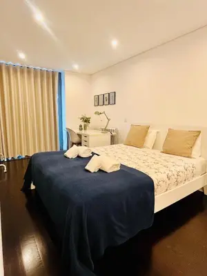 a bedroom with a large bed with a blue blanket at PATEO LUSO - Cozy Apartment City Center in Porto