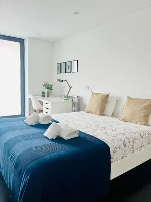 a bedroom with a large bed with two towels on it at PATEO LUSO - Cozy Apartment City Center in Porto