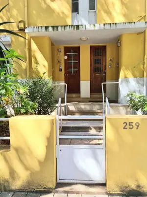 a yellow house with stairs leading to a door at Oporto Yellow Villas in Porto