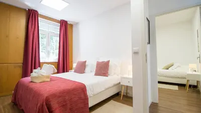 a bedroom with a bed with a red blanket at Oporto Yellow Villas in Porto
