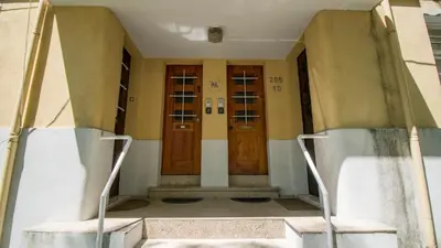 a hallway with two wooden doors in a building at Oporto Yellow Villas in Porto