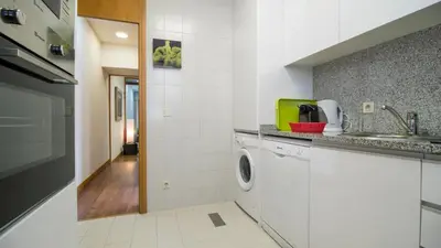 a kitchen with a washing machine and a sink at Oporto Yellow Villas in Porto