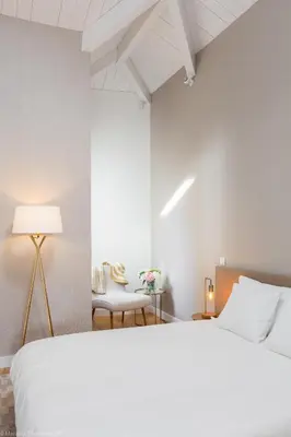 a white bedroom with a large bed and a table at Comercio RIBEIRA Luxury Penthouse Apartment in Porto