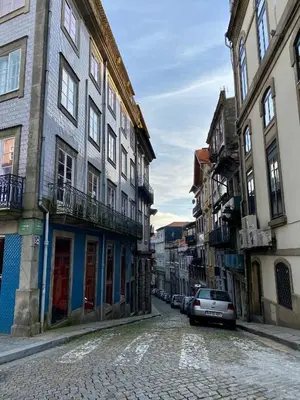 a street with buildings and a car parked on a street at Comercio RIBEIRA Luxury Penthouse Apartment in Porto