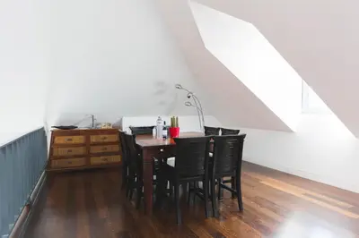 a dining room with a table and black chairs at APOSENTUS - Downtown Porto Modern Penthouse in Porto