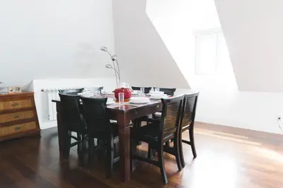 a dining room table with black chairs around it at APOSENTUS - Downtown Porto Modern Penthouse in Porto