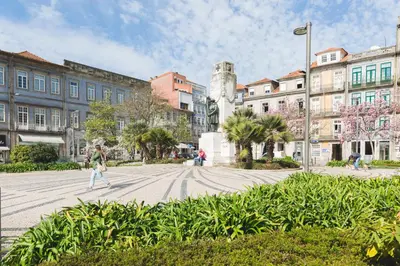 a person walking down a street in a city at APOSENTUS - Downtown Porto Modern Penthouse in Porto