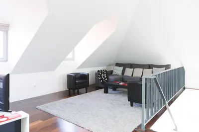 a living room with a couch and a table at APOSENTUS - Downtown Porto Modern Penthouse in Porto