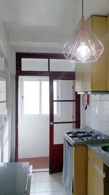 a kitchen with a stove and a window and a door at Ribeira Vintage Suite in Porto
