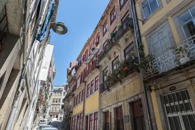 a city street with buildings and cars on the street at Ribeira Vintage Suite in Porto