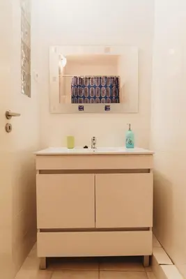 a bathroom with a sink and a mirror at Ribeira Vintage Suite in Porto