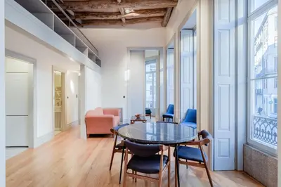 a dining room with a glass table and chairs at BOUTIQUE Rentals - Toledos One & Only Apt in Historical center of Porto in Porto