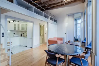 a dining room with a glass table and blue chairs at BOUTIQUE Rentals - Toledos One & Only Apt in Historical center of Porto in Porto