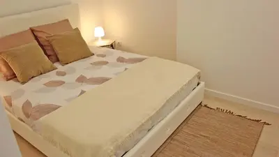 a bed in a small room with at São João Oporto Residence I & II in Porto