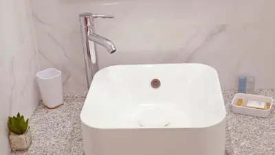 a bathroom with a white sink and aaucet at São João Oporto Residence I & II in Porto