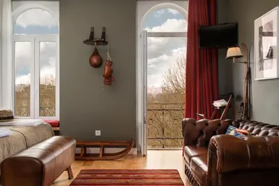 a living room with a couch and a window at VIVA Casa da Praça with Pool and terrace in Porto