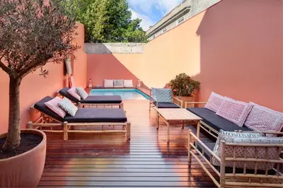 a patio with chairs and a swimming pool at VIVA Casa da Praça with Pool and terrace in Porto