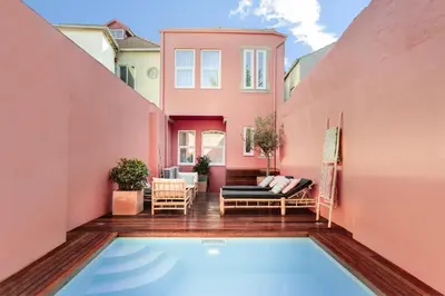 a house with a swimming pool in front of a house at VIVA Casa da Praça with Pool and terrace in Porto