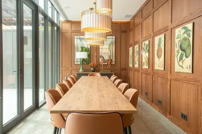 a conference room with a long table and chairs at NH Porto Jardim in Porto