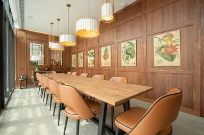 a conference room with a long table and chairs at NH Porto Jardim in Porto