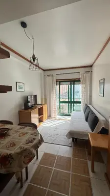 a room with a bed and a couch and a window at Musica4 in Porto