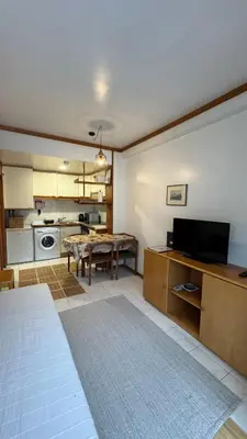 a living room with a table and a kitchen at Musica4 in Porto