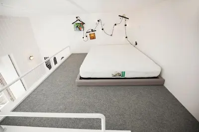 a room with a bed in a white room at GET Lights and Books in Flat in Porto
