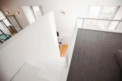 an open staircase in a room with white walls at GET Lights and Books in Flat in Porto