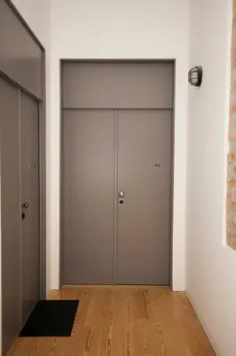 a hallway with two garage doors and a wooden floor at GET Lights and Books in Flat in Porto