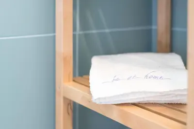 a stack of towels sitting on a shelf at Fontainhas Design Apartment by DA'HOME in Porto