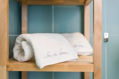 two towels sitting on a shelf in a cabinet at Fontaínhas Stylish Apartment by DA'HOME in Porto