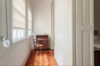 a room with a chair and a desk and a window at O da Joana in Porto
