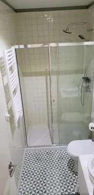 a bathroom with a shower and a toilet and a sink at Oporto Histórico - Bonjardim in Porto