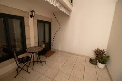 a balcony with a table and chairs in a room at Oporto Histórico - Bonjardim in Porto