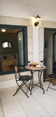 a table and chairs in a room with a bedroom at Oporto Histórico - Bonjardim in Porto