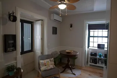 a living room with a table and a chair at Oporto Histórico - Bonjardim in Porto