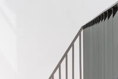 a tall building with a fence on the side of it at Backyard Palace Terrace in Porto