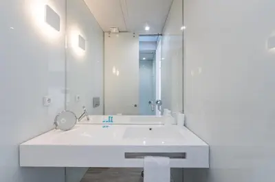 a white bathroom with a sink and a mirror at Backyard Palace Terrace in Porto