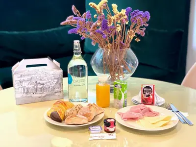 a table with two plates of food and a vase of flowers at Go2oporto - Ribeira do Porto in Porto
