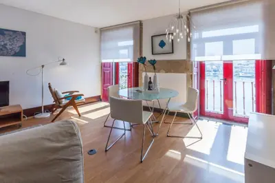 a living room with a glass table and chairs at Go2oporto - Ribeira do Porto in Porto