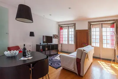 a living room with a table and a couch at Go2oporto - Ribeira do Porto in Porto