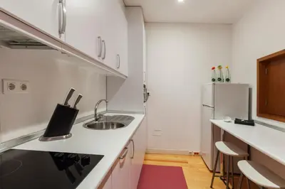 a small kitchen with a sink and a refrigerator at Go2oporto - Ribeira do Porto in Porto