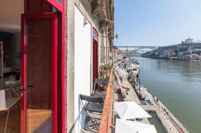 a balcony with a view of the river at Go2oporto - Ribeira do Porto in Porto