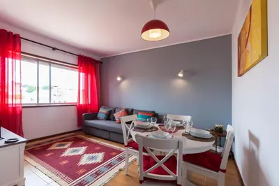 a living room with a table and a couch at Casa do Antonio in Porto