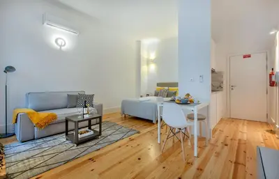 a white kitchen with a microwave and a sink at Santa Catarina Experience in Porto in Porto