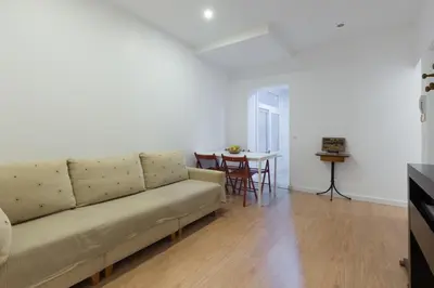 a living room with a couch and a table at Porto Belomonte Flats in Porto