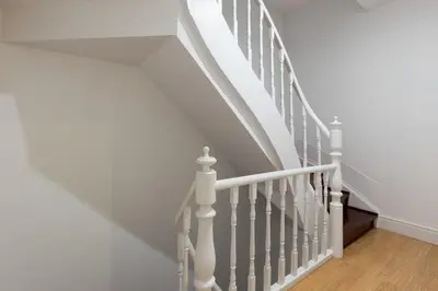 a white staircase with white railings in a home at Porto Belomonte Flats in Porto