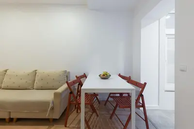 a living room with a couch and a table and chairs at Porto Belomonte Flats in Porto