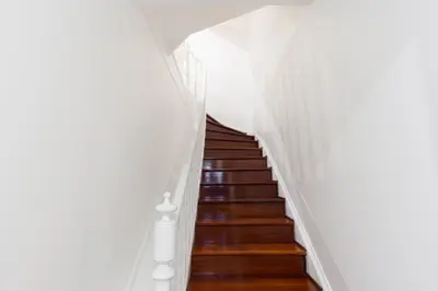 a staircase in a building with wooden floors and white walls at Porto Belomonte Flats - T2 in Porto