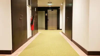 a hallway with doors and a yellow carpet at Porto City Hotel in Porto